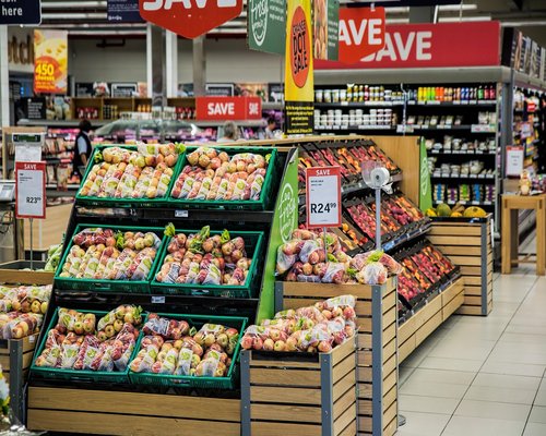 Person carefully reading nutritional label in grocery store